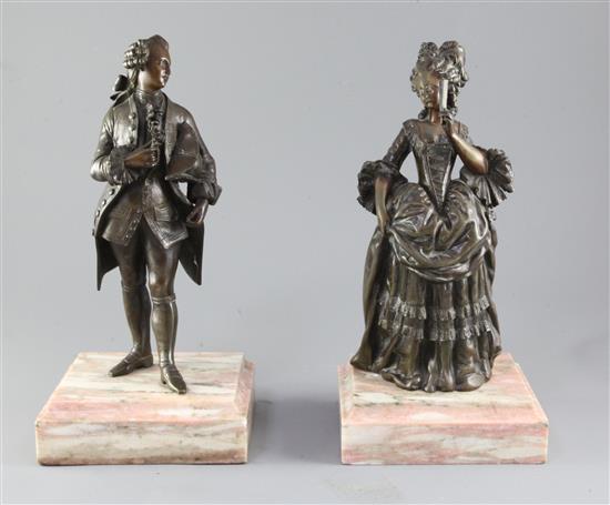 A pair of 19th century bronze figures of an elegant lady and a gentleman
